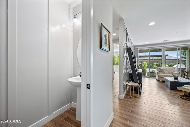 bathroom featuring hardwood / wood-style floors and plenty of natural light