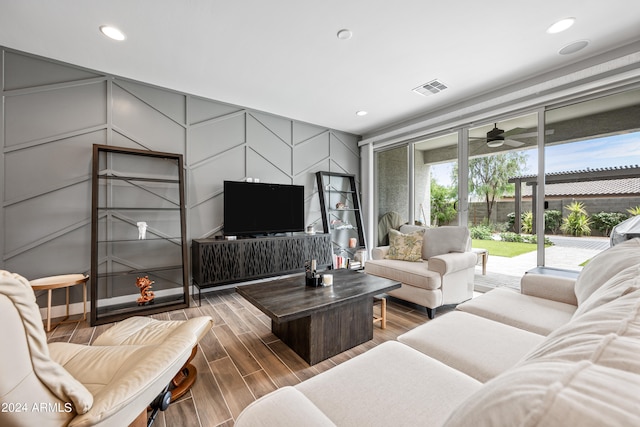 living room featuring wood-type flooring and ceiling fan