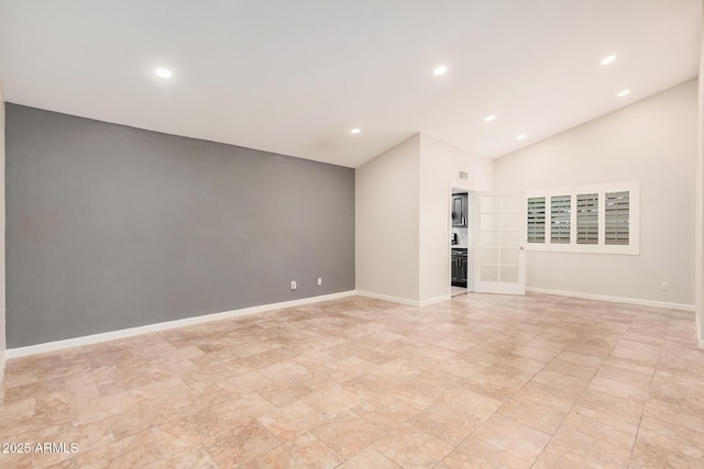 10244 N 65th Ln, Glendale, AZ 85302 - spare room featuring recessed lighting, baseboards, and vaulted ceiling