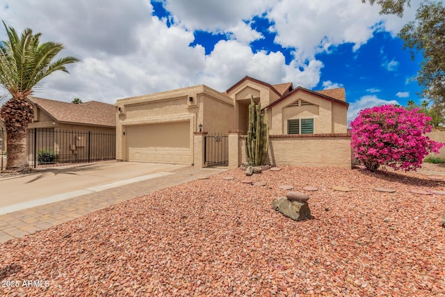 10244 N 65th Ln, Glendale, AZ 85302 - ranch-style house featuring stucco siding, an attached garage, driveway, and a gate