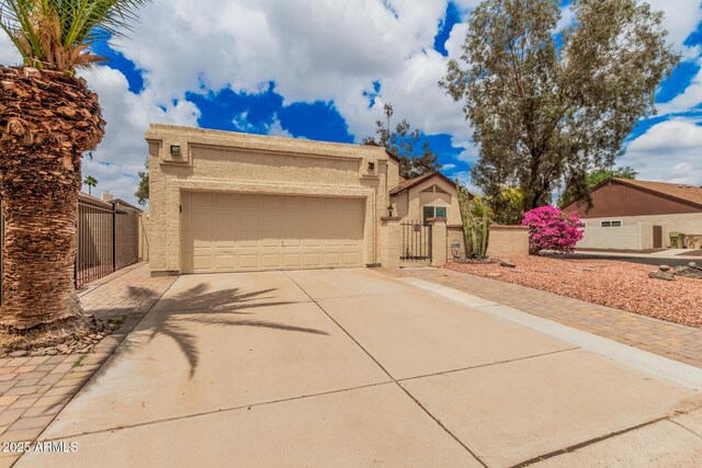 10244 N 65th Ln, Glendale, AZ 85302 - view of front of property featuring a gate, concrete driveway, stucco siding, a garage, and fence