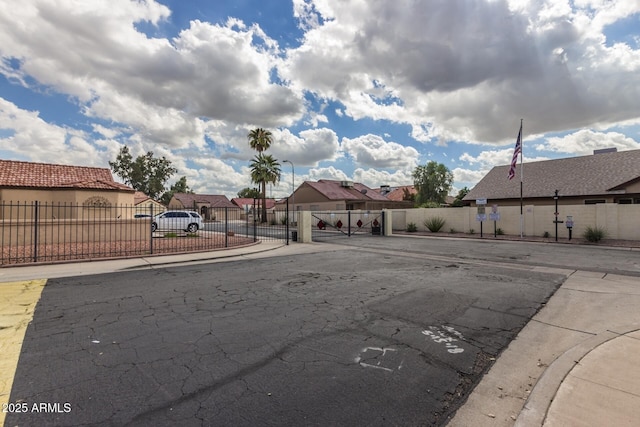 10244 N 65th Ln, Glendale, AZ 85302 - view of street with a residential view, a gate, sidewalks, and a gated entry