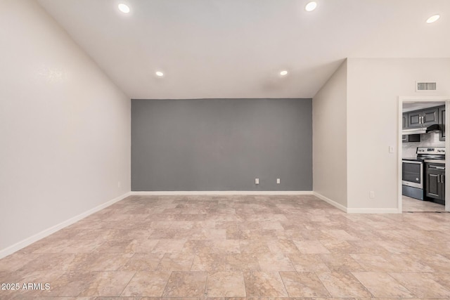 10244 N 65th Ln, Glendale, AZ 85302 - unfurnished living room featuring recessed lighting, baseboards, and stone finish floors