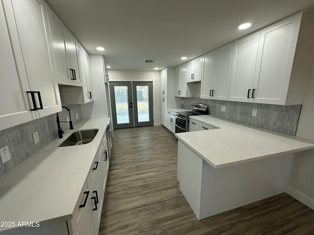 1930 W Missouri Ave, Phoenix, AZ 85015 - kitchen with range with two ovens, white cabinets, dark wood-style flooring, and recessed lighting