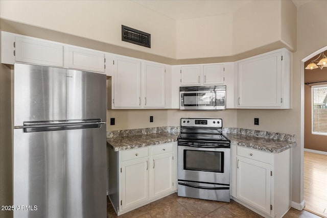 1520 E Flint St, Chandler, AZ 85225 - kitchen with visible vents, white cabinets, and appliances with stainless steel finishes