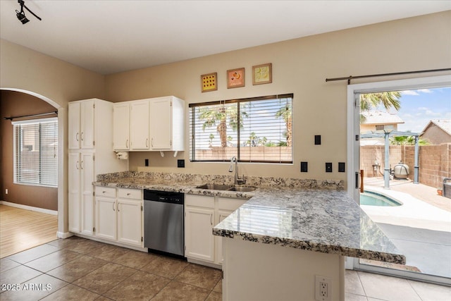1520 E Flint St, Chandler, AZ 85225 - kitchen featuring dishwasher, light tile patterned floors, light stone counters, a sink, and white cabinets
