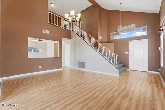 1520 E Flint St, Chandler, AZ 85225 - unfurnished living room with baseboards, high vaulted ceiling, visible vents, and wood finished floors