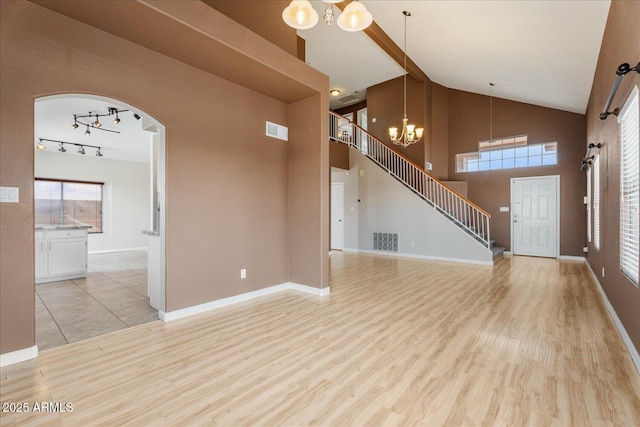 1520 E Flint St, Chandler, AZ 85225 - unfurnished living room featuring an inviting chandelier, light wood-style floors, and visible vents