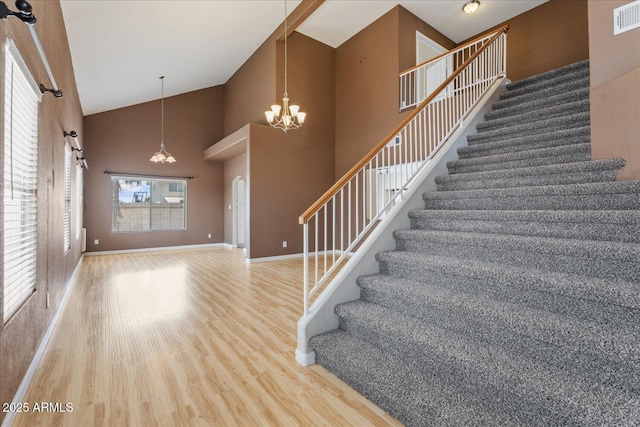 1520 E Flint St, Chandler, AZ 85225 - stairway featuring wood finished floors, high vaulted ceiling, visible vents, an inviting chandelier, and baseboards