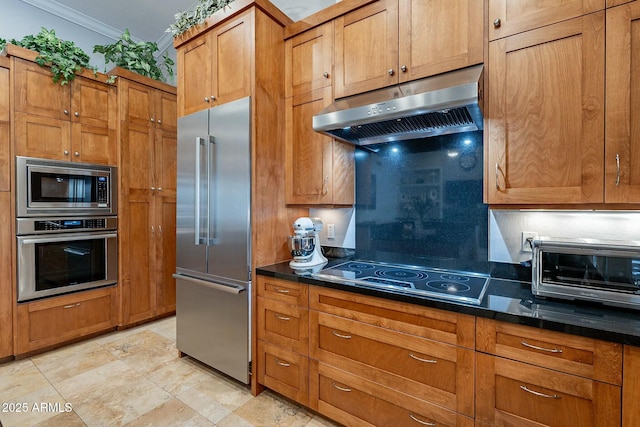 kitchen featuring crown molding and built in appliances