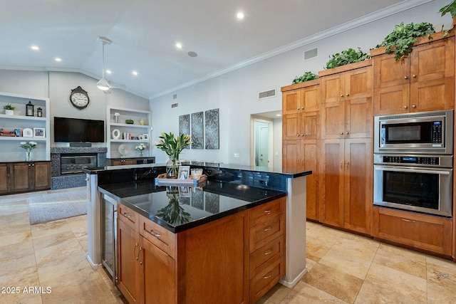 kitchen featuring built in shelves, lofted ceiling, a center island, dark stone countertops, and stainless steel appliances