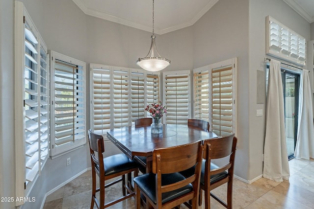 dining space featuring a towering ceiling and ornamental molding