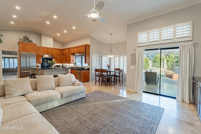 living room featuring crown molding, sink, ceiling fan, and high vaulted ceiling