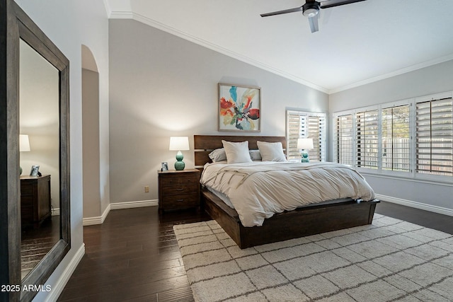 bedroom featuring lofted ceiling, dark wood-type flooring, ornamental molding, and ceiling fan