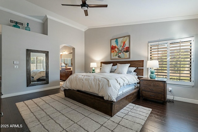 bedroom featuring ornamental molding, dark hardwood / wood-style floors, vaulted ceiling, and multiple windows