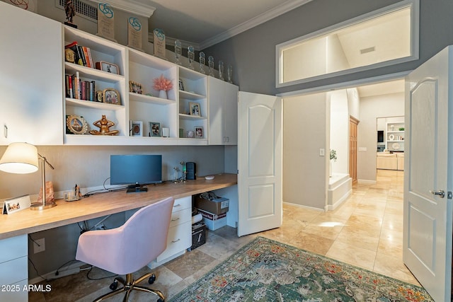 home office with built in desk and ornamental molding