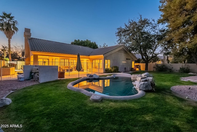 pool at dusk with a yard