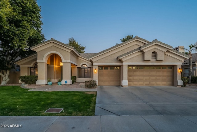 view of front facade featuring a garage and a front lawn