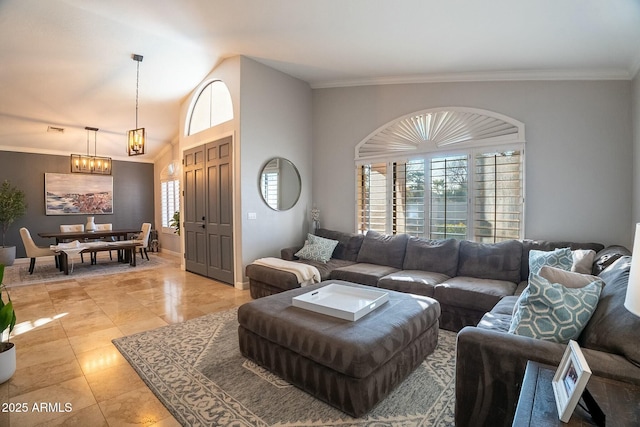 living room featuring crown molding, vaulted ceiling, and an inviting chandelier