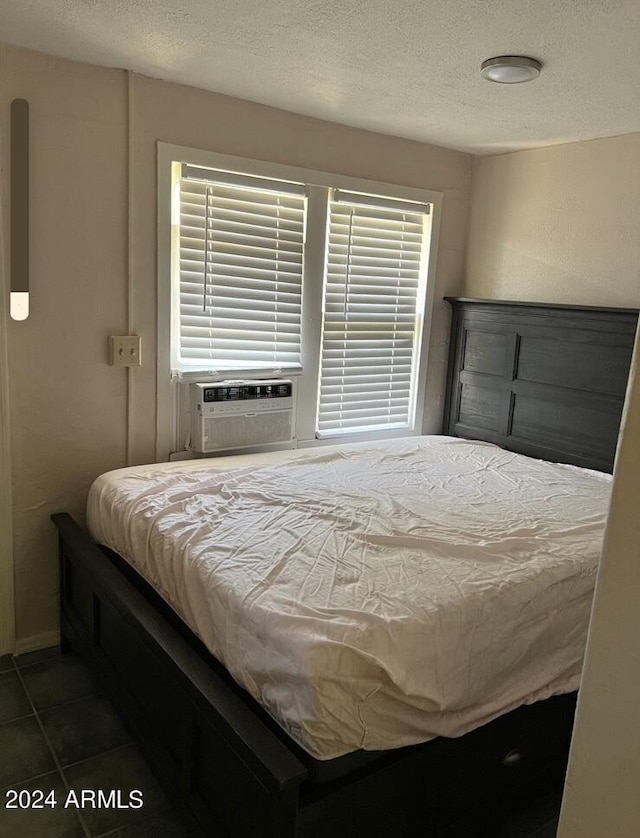 tiled bedroom with a textured ceiling and cooling unit