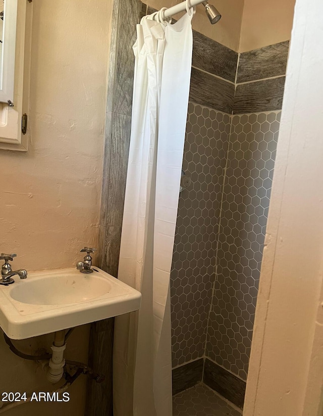 full bathroom with a sink and a stall shower