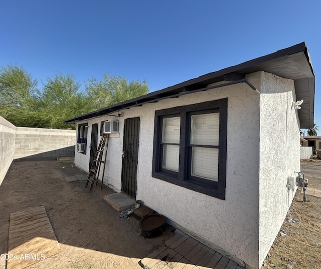 view of property exterior featuring a fenced backyard and stucco siding