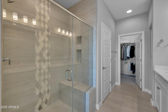 bathroom with vanity and a shower with shower door