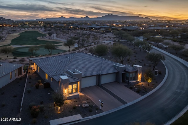 aerial view at dusk featuring a mountain view