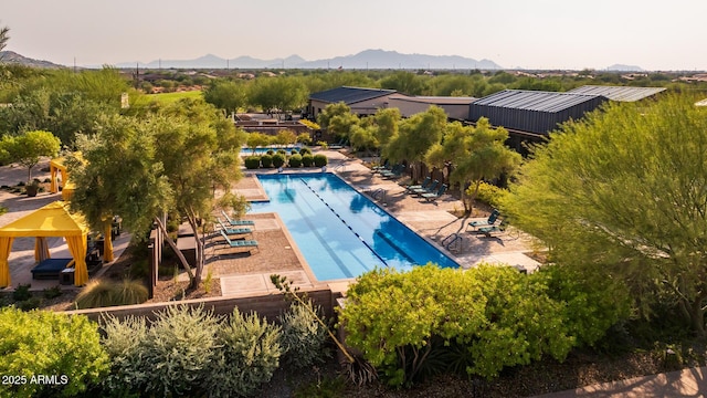 view of swimming pool featuring a gazebo, a mountain view, and a patio area