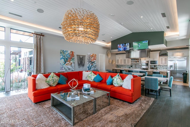 living room with a raised ceiling, wood ceiling, dark hardwood / wood-style floors, and a chandelier