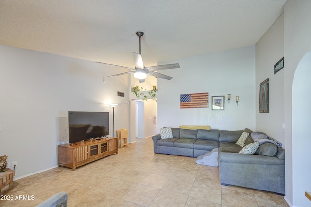 5424 E Florian Ave, Mesa, AZ 85206 - living area featuring a ceiling fan, vaulted ceiling, arched walkways, and light tile patterned floors