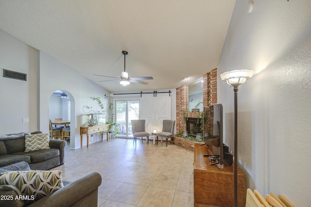5424 E Florian Ave, Mesa, AZ 85206 - living area featuring arched walkways, light tile patterned flooring, ceiling fan, and a barn door