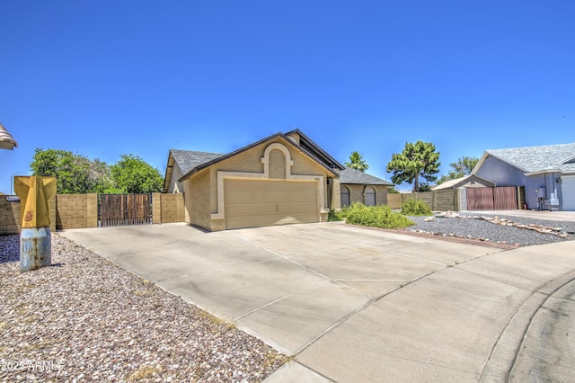 5424 E Florian Ave, Mesa, AZ 85206 - ranch-style home featuring a gate, a garage, concrete driveway, and stucco siding