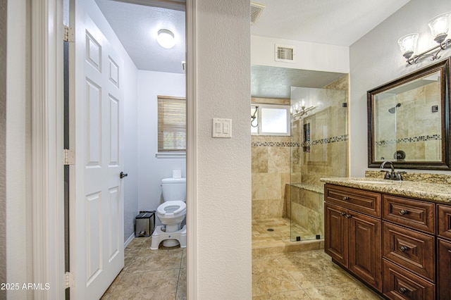 5424 E Florian Ave, Mesa, AZ 85206 - bathroom with toilet, tiled shower, vanity, tile patterned floors, and a textured wall