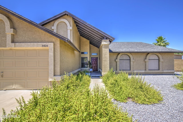 5424 E Florian Ave, Mesa, AZ 85206 - view of front of property with a garage, stucco siding, a shingled roof, and driveway