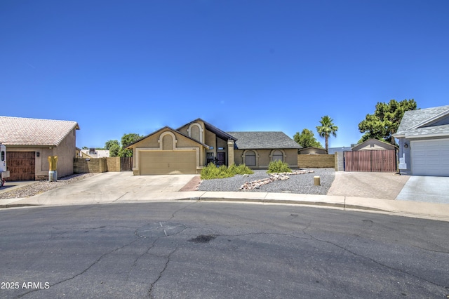 5424 E Florian Ave, Mesa, AZ 85206 - view of front of home with driveway, a gate, an attached garage, and stucco siding