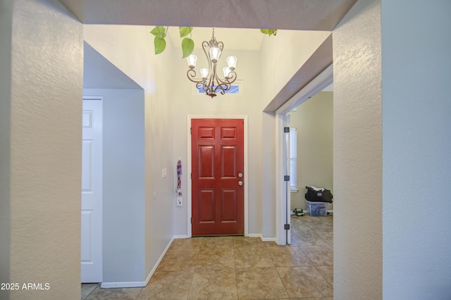 5424 E Florian Ave, Mesa, AZ 85206 - entrance foyer with a chandelier, baseboards, a textured wall, and tile patterned flooring