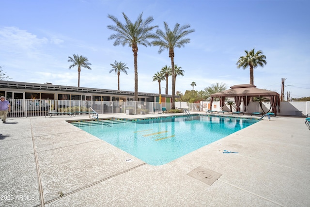 pool featuring a patio area, fence, and a gazebo