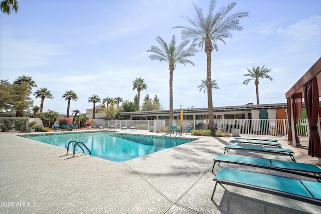 community pool featuring a patio area and fence