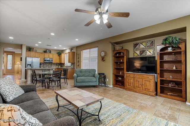 living room with plenty of natural light and ceiling fan