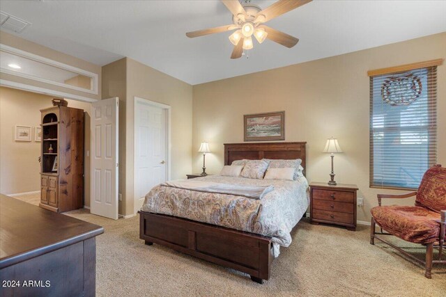 bedroom with light colored carpet and ceiling fan