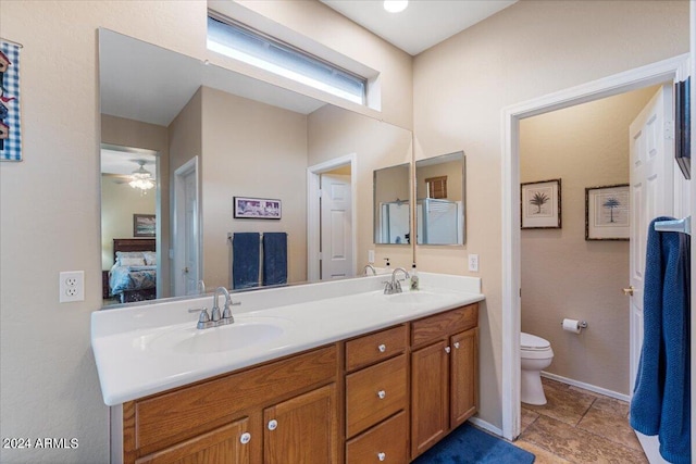 bathroom featuring ceiling fan, toilet, and vanity