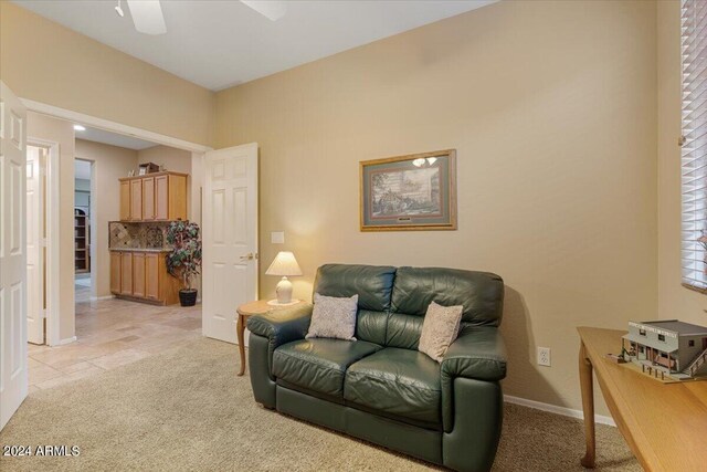 living room featuring light colored carpet and ceiling fan