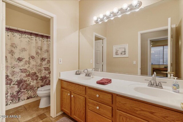 bathroom featuring vanity, toilet, and a shower with shower curtain