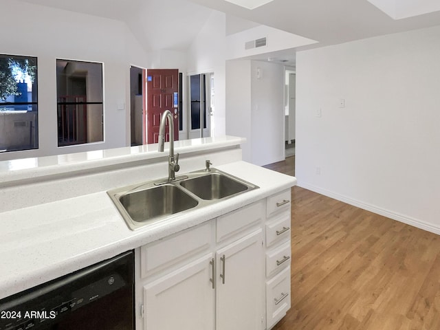 kitchen with sink, light hardwood / wood-style flooring, dishwasher, white cabinetry, and lofted ceiling