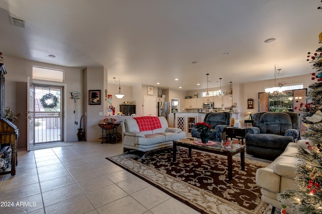 tiled living room featuring an inviting chandelier