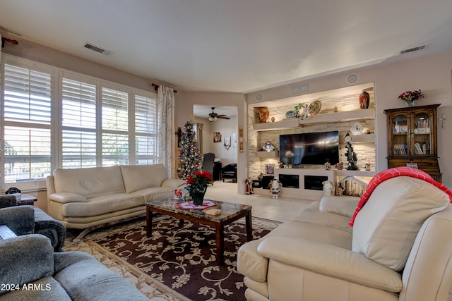 living room with tile patterned floors, a wealth of natural light, and ceiling fan