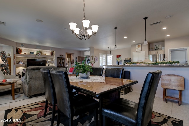 tiled dining area with an inviting chandelier