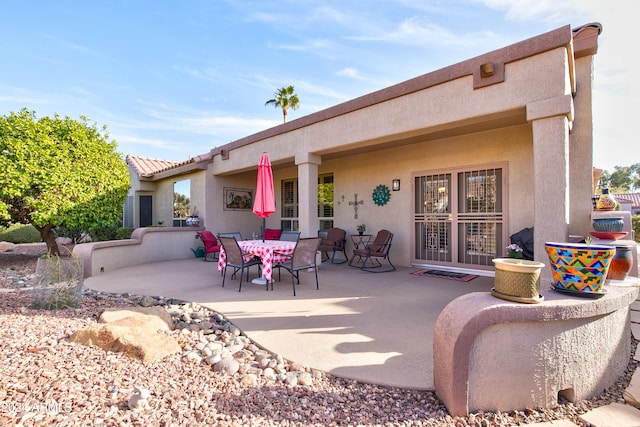 back of house with a patio