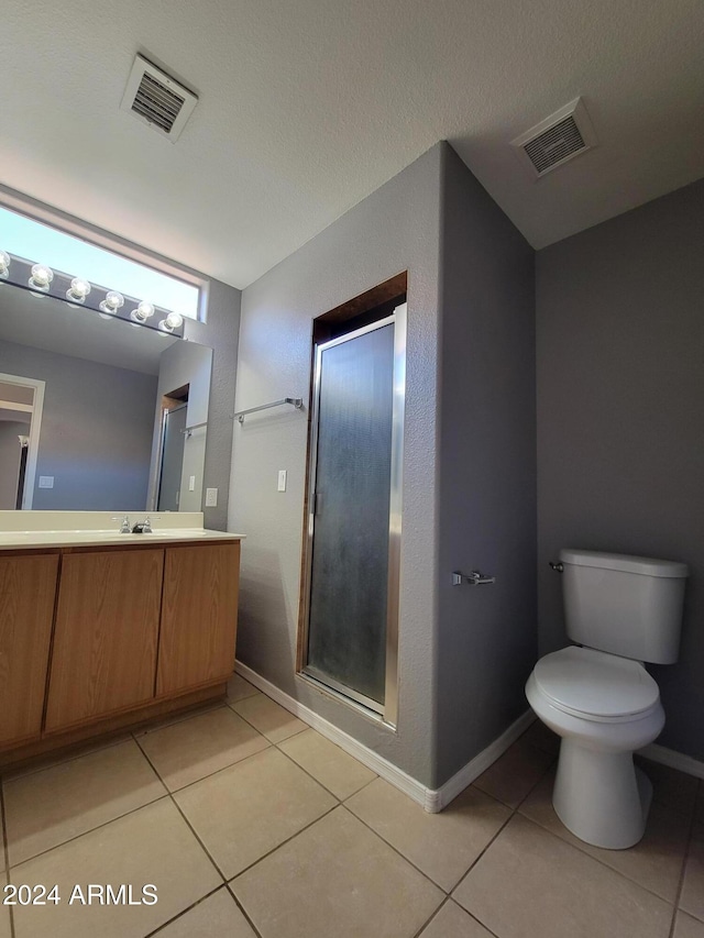 bathroom featuring tile patterned flooring, vanity, and toilet